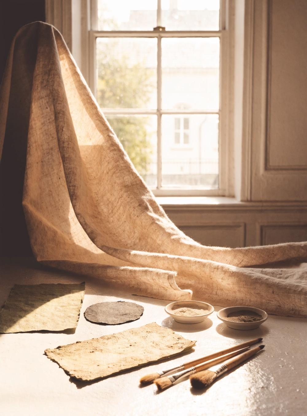 Raw linen, pigment and brushes in window light