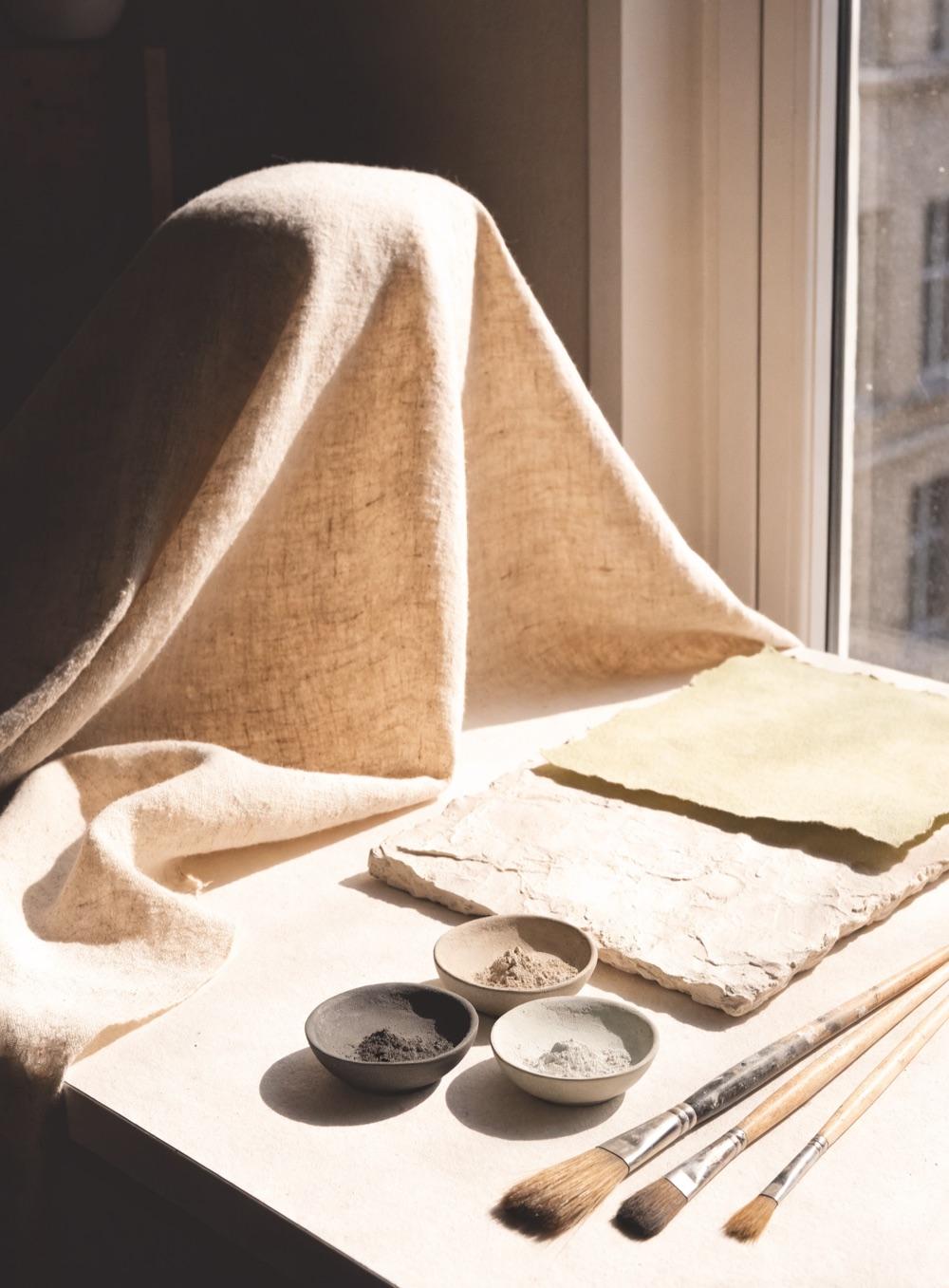 Linen, handmade paper and pigment on a sunlit worktable